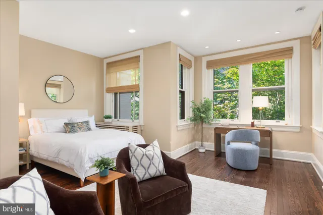 a bedroom with a bed and glass window