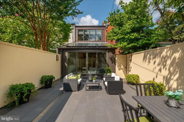 a view of a patio with table and chairs and potted plants