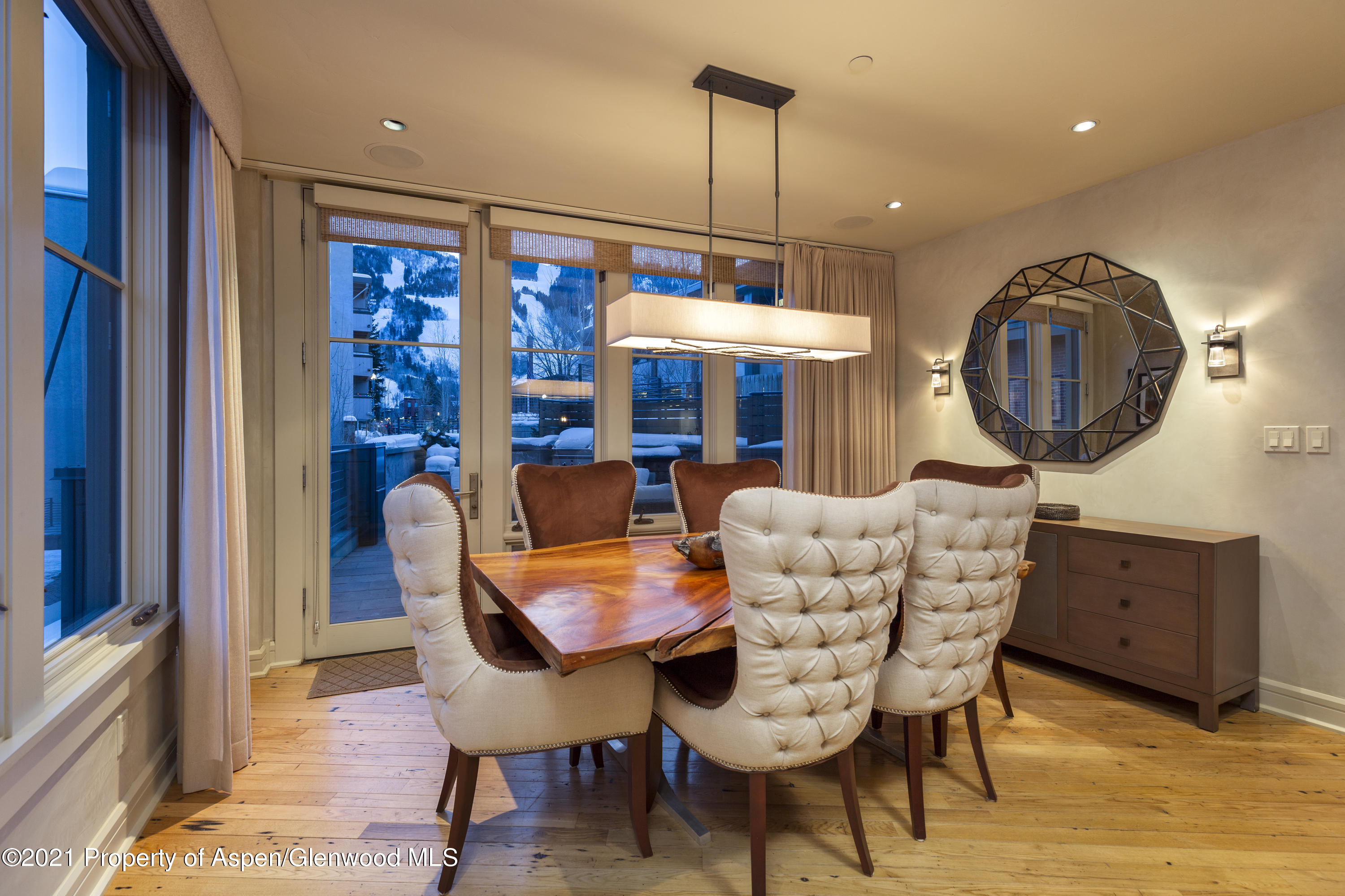 101 Founders Place, Unit 202 Aspen, CO 81611 - Photo 13 of 26 a view of a dining room with furniture window and wooden floor