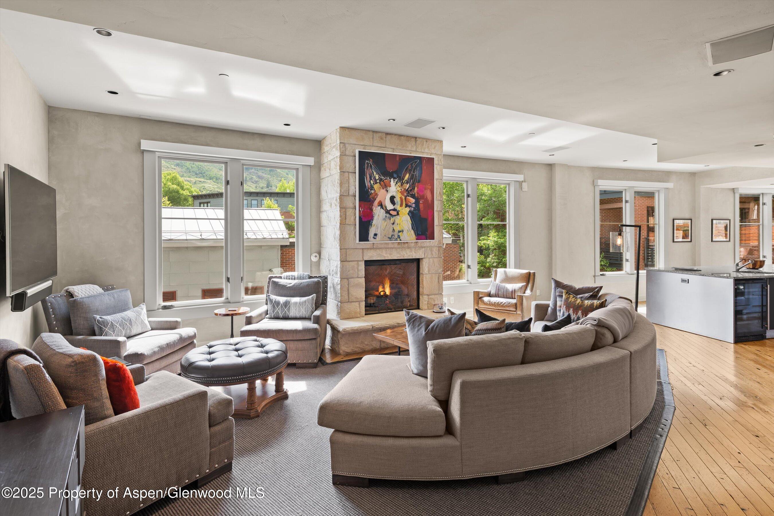 101 Founders Place, Unit 202 Aspen, CO 81611 - Photo 14 of 26 a living room with fireplace furniture and a large window