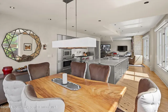 a living room with stainless steel appliances kitchen island granite countertop furniture and a view of kitchen