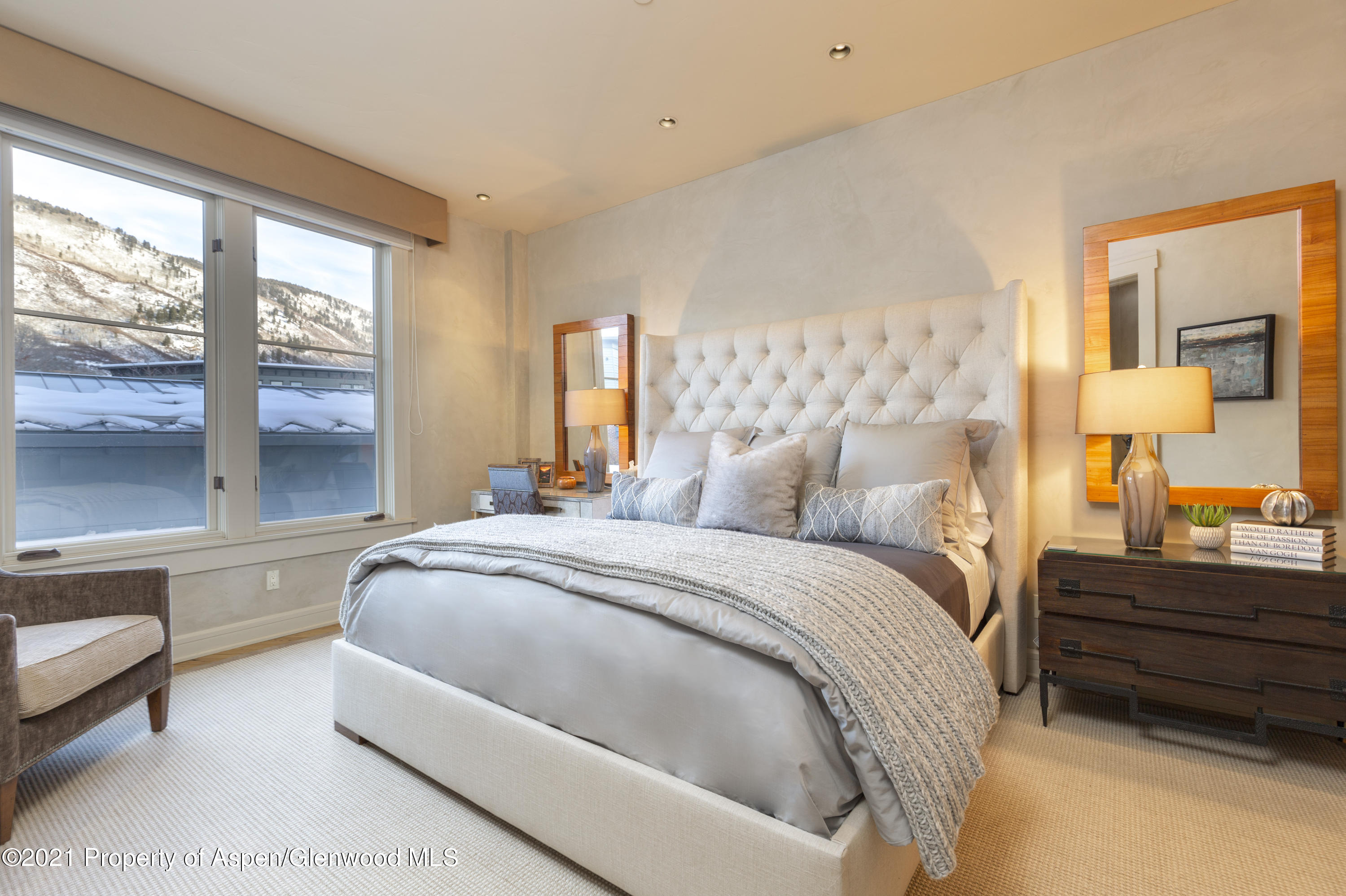 101 Founders Place, Unit 202 Aspen, CO 81611 - Photo 2 of 26 a bedroom with a bed and a large window