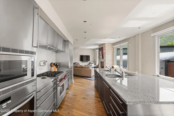 a kitchen with stove and cabinets