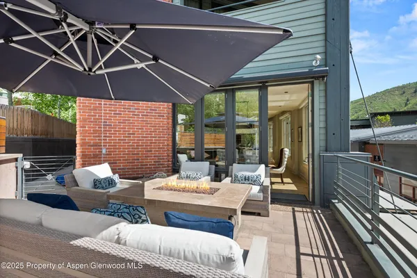 a outdoor living space with patio furniture and a fireplace