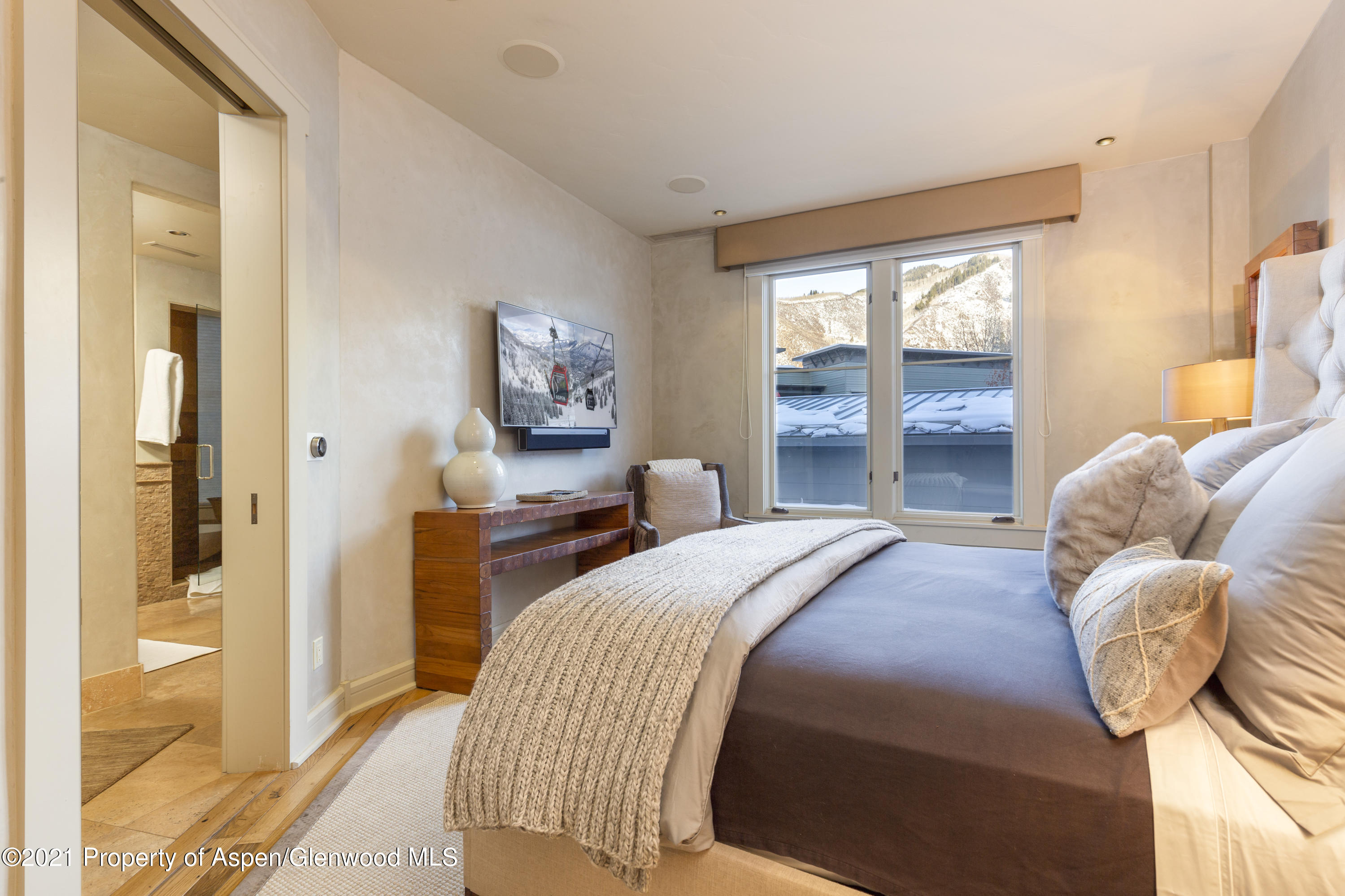 101 Founders Place, Unit 202 Aspen, CO 81611 - Photo 3 of 26 a bedroom with a bed and a large window