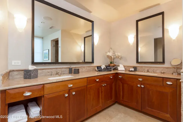 a bathroom with a double vanity sink and a mirror