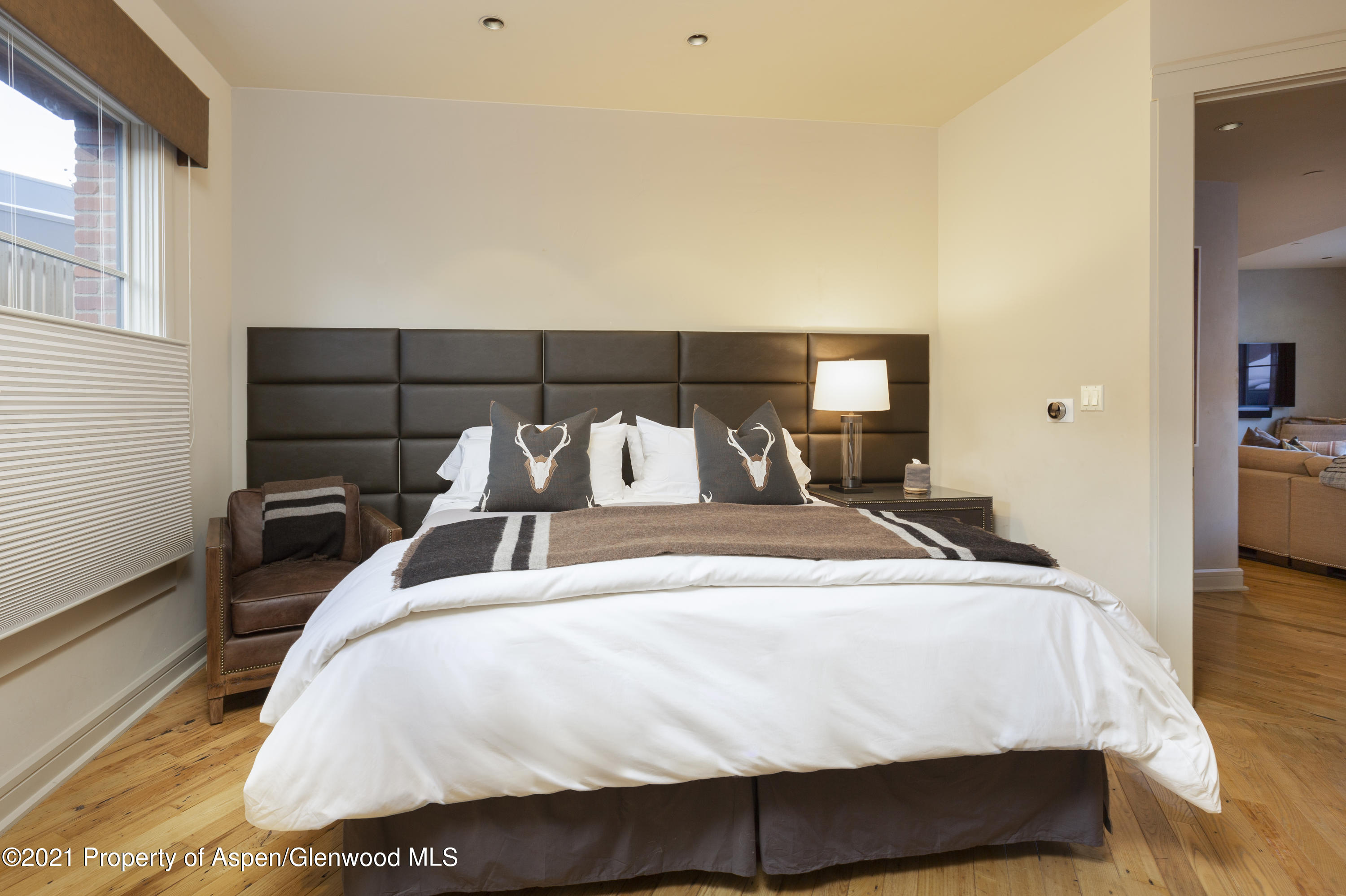 101 Founders Place, Unit 202 Aspen, CO 81611 - Photo 7 of 26 a large bed sitting in a bedroom next to a window