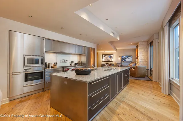 a kitchen with cabinets and stainless steel appliances