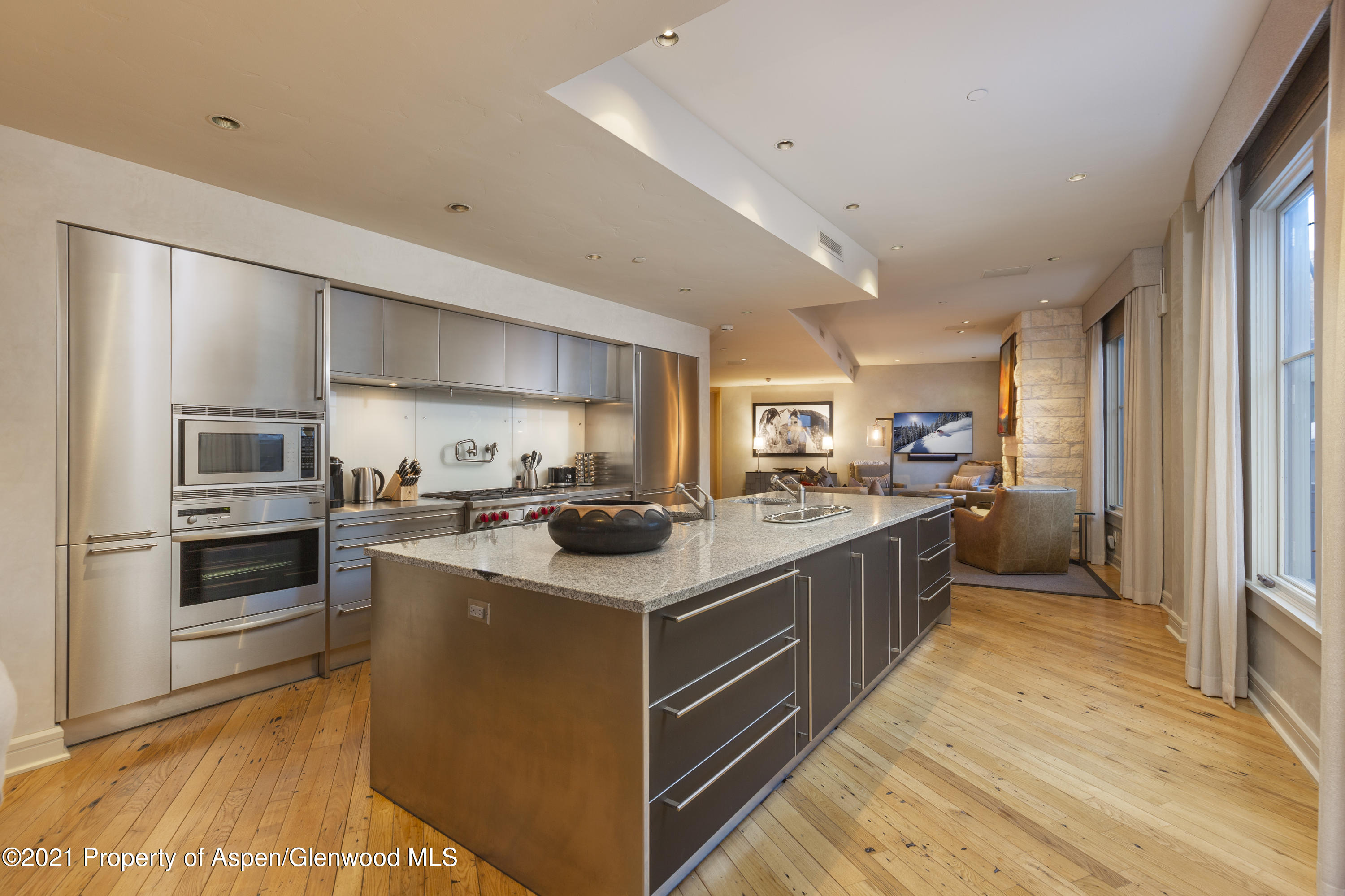 101 Founders Place, Unit 202 Aspen, CO 81611 - Photo 9 of 26 a kitchen with cabinets and stainless steel appliances