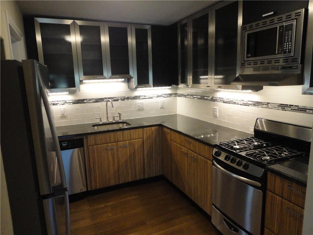 3311 Speedway, Unit B Austin, TX 78705 - Photo 5 of 23 a kitchen with granite countertop a stove and a sink