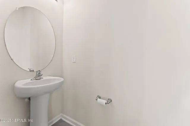 an aerial view of a house with a garden and lake view