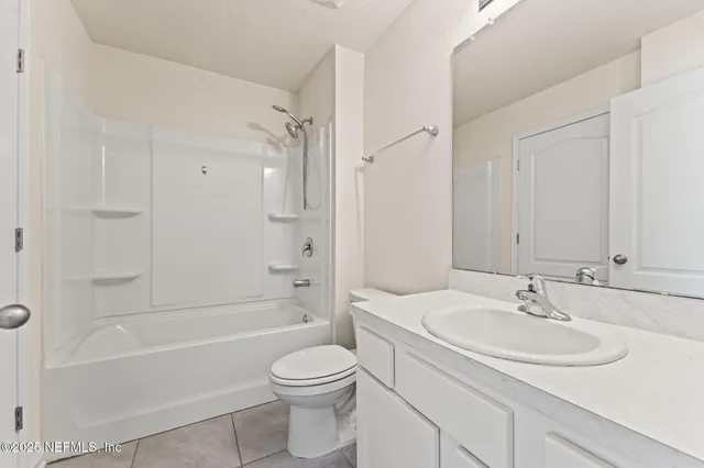 a view of swimming pool with lounge chair and dinning table under large trees