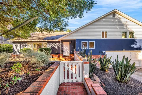 a view of a house with backyard and sitting area