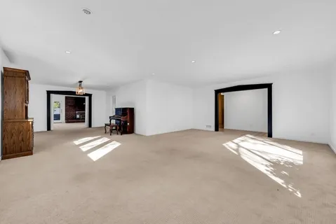 a view of empty room with furniture and a fireplace