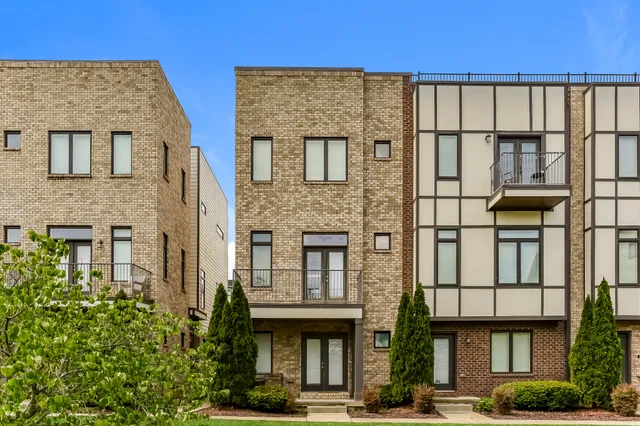 a front view of a building with a garden