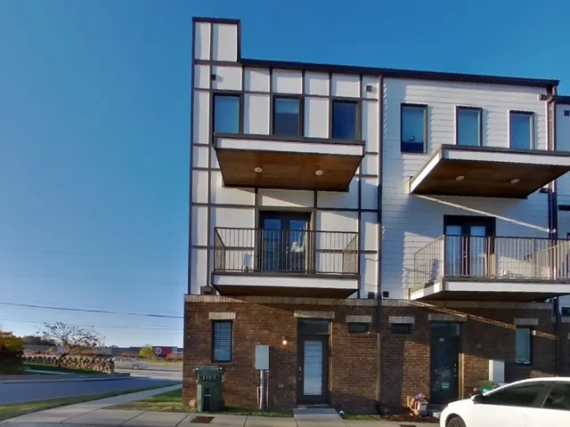 a view of a brick house with large windows