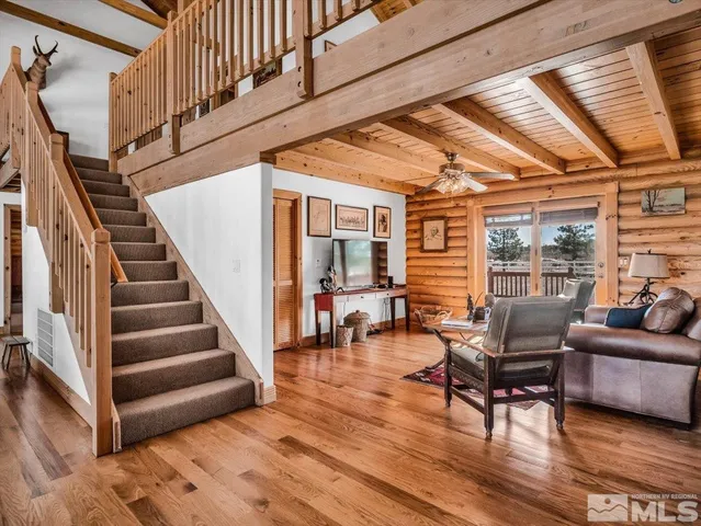 a living room with furniture and wooden floors