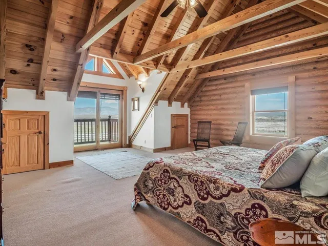 a bed sitting in a bedroom next to a balcony