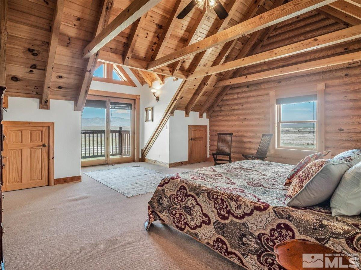 250 Olson Rnch Road Smith, NV 89430 - Photo 24 of 38 a bed sitting in a bedroom next to a balcony