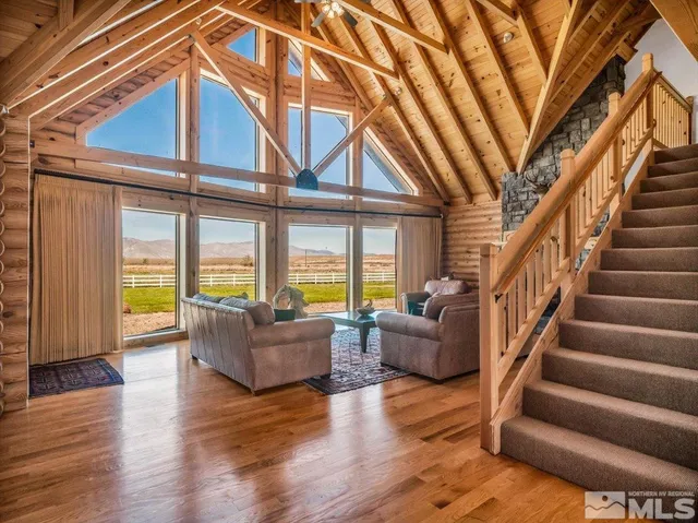 a living room with furniture and hard wood flooring