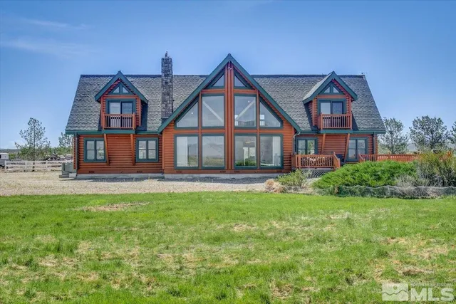 a front view of a house with yard and green space