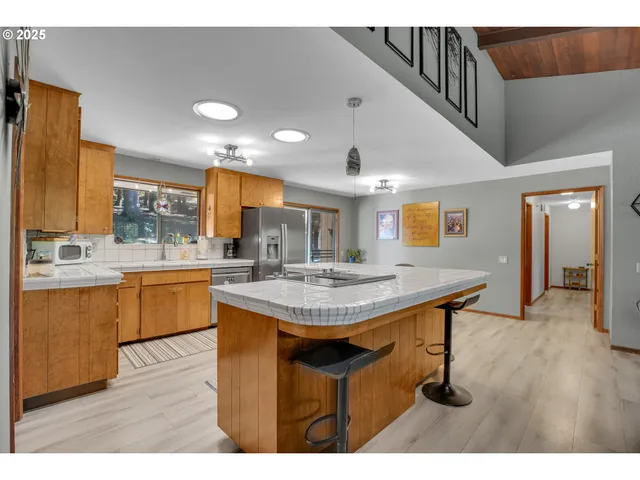 a kitchen with kitchen island a sink table and chairs