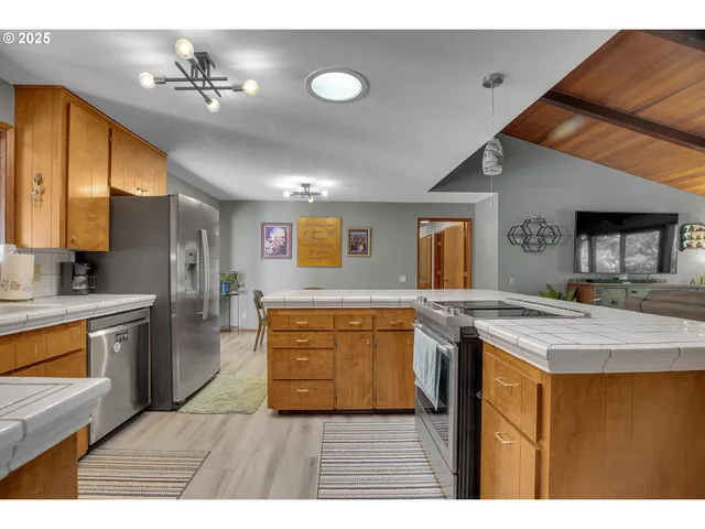 a kitchen with stainless steel appliances granite countertop a sink and cabinets