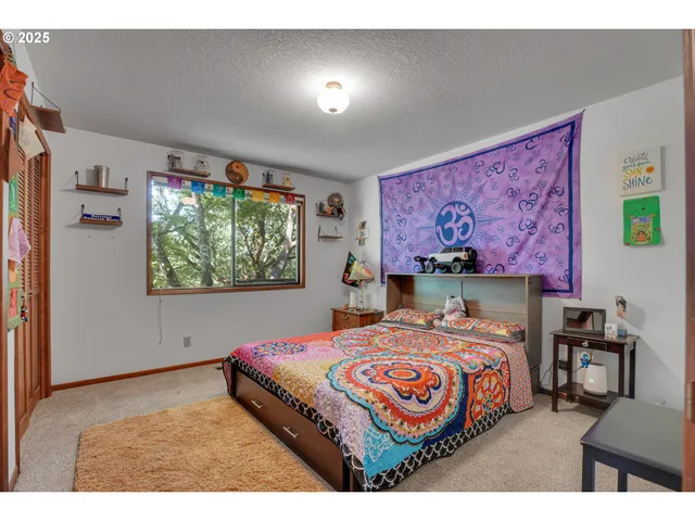 a bedroom with a bed and a painting on the wall