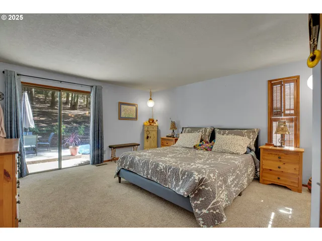 a bedroom with a bed and large window
