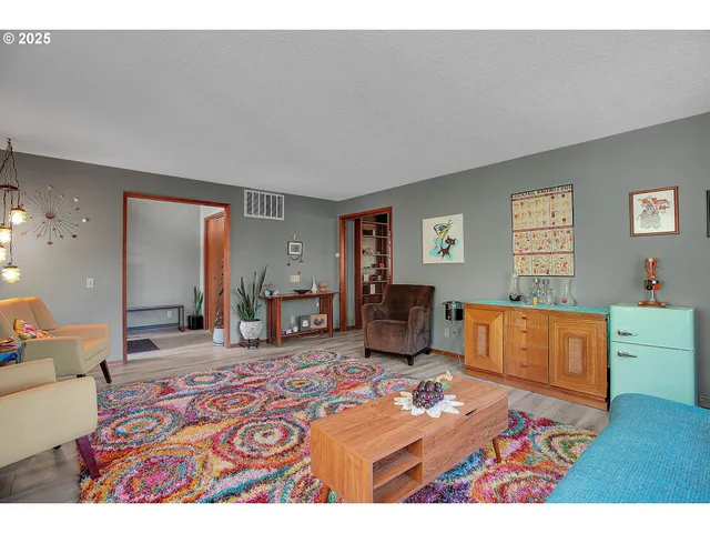a bedroom with furniture and a wooden floor