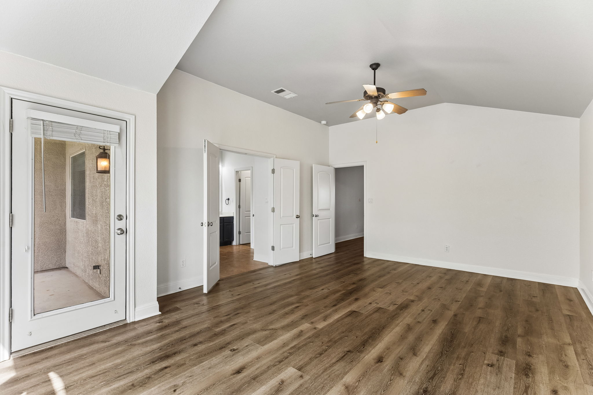 114 Aria Ridge, Unit 802 Lakeway, TX 78738 - Photo 30 of 37 A spacious room with vaulted ceilings and wood-look flooring, offering versatile living options.