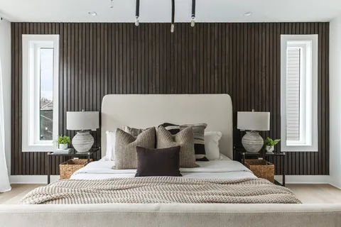 a bed sitting in a bedroom next to a window