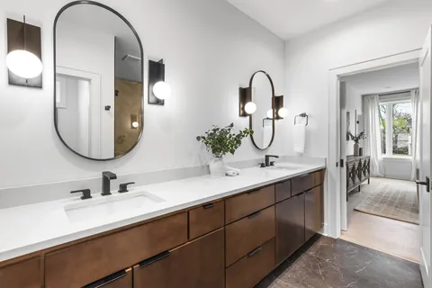 a bathroom with a double vanity sink and a mirror