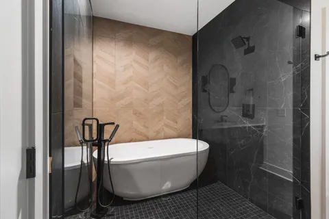 a bathroom with a bathtub and shower