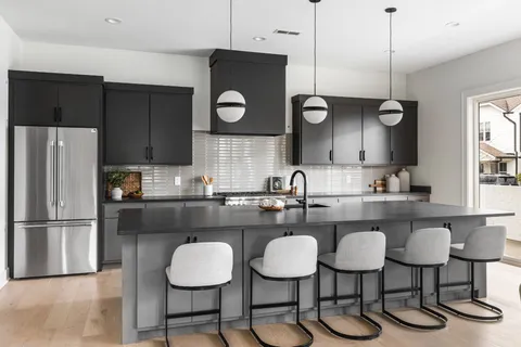 a kitchen with a table chairs stove and microwave