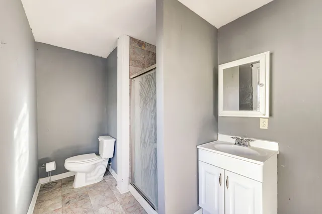 a bathroom with a toilet a sink and a mirror