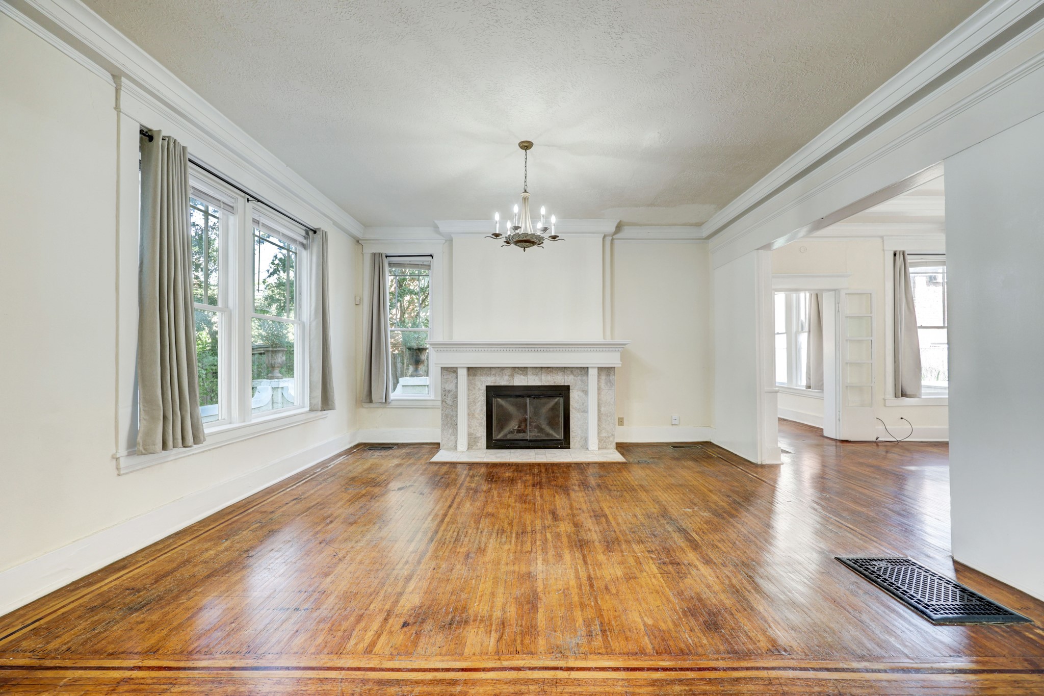 222 Marshall Street Houston, TX 77006 - Photo 9 of 35 a view of an empty room with wooden floor fireplace and a window
