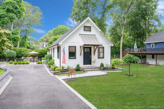 a front view of house with a garden and patio