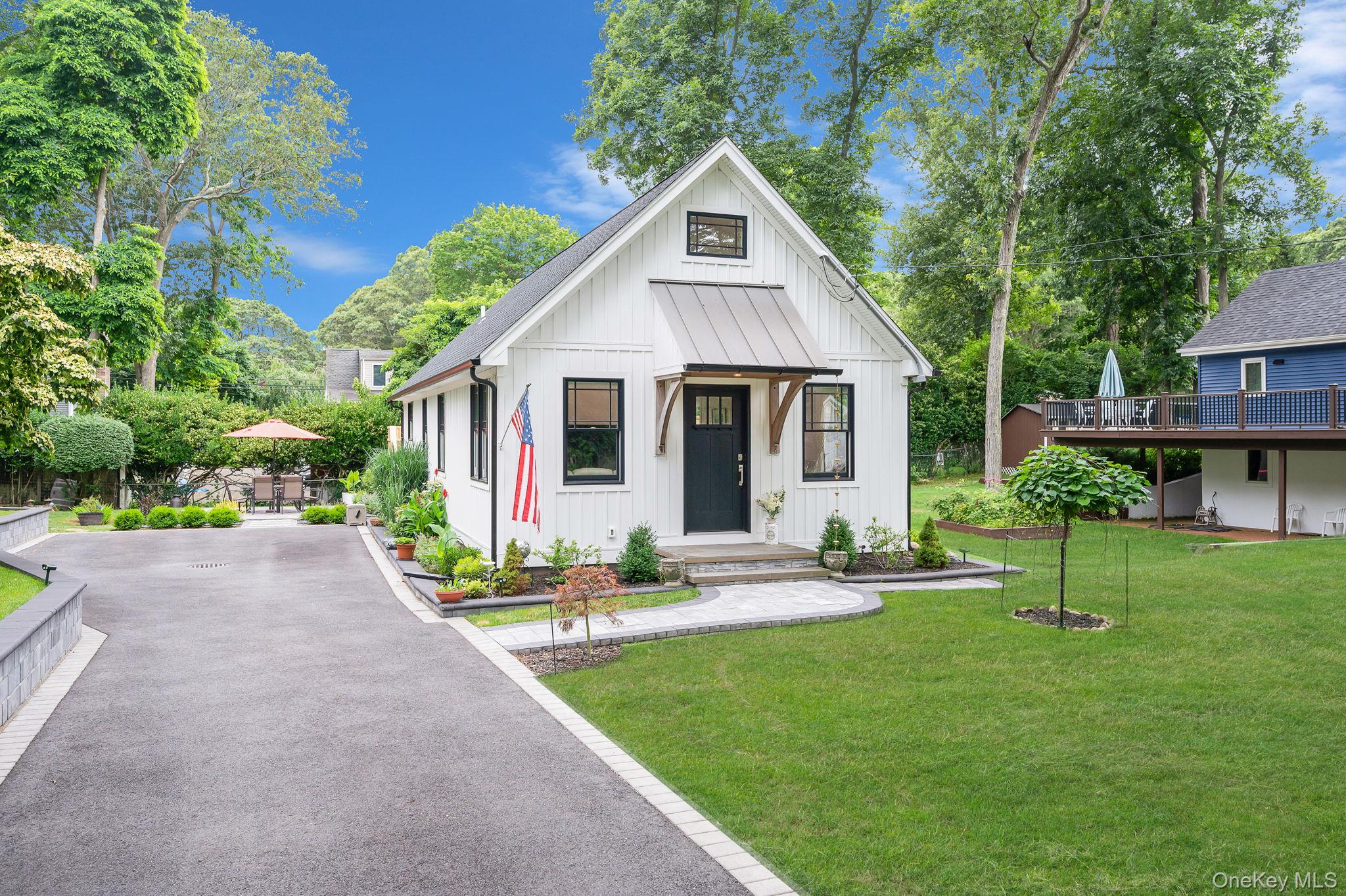 a front view of house with a garden and patio