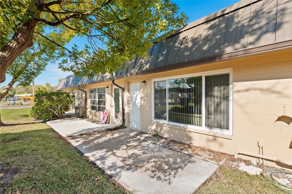 4409 Summersun Drive New Port Richey, FL 34652 - Photo 16 of 23 a view of a house with a tree in a yard