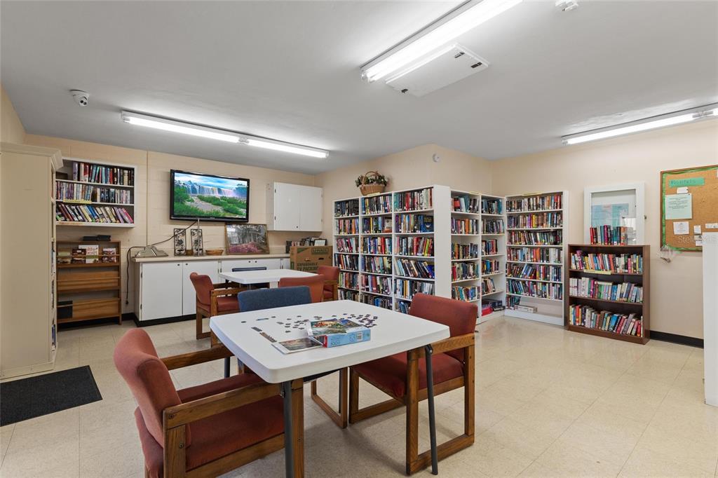 4409 Summersun Drive New Port Richey, FL 34652 - Photo 22 of 23 a view of a workspace with furniture and bookshelf