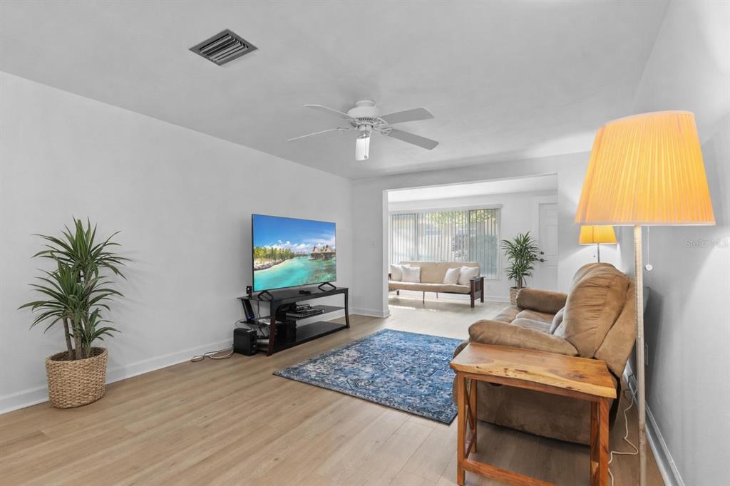 4409 Summersun Drive New Port Richey, FL 34652 - Photo 6 of 23 a living room with furniture and a flat screen tv