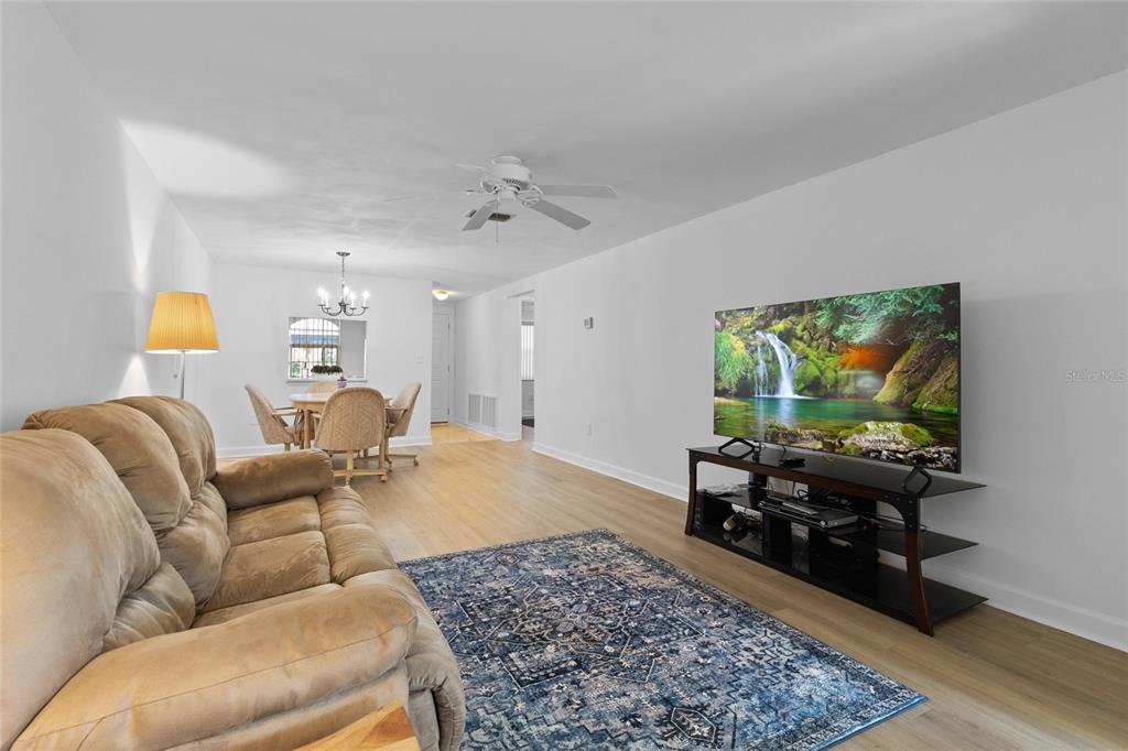 4409 Summersun Drive New Port Richey, FL 34652 - Photo 7 of 23 a living room with furniture and a flat screen tv