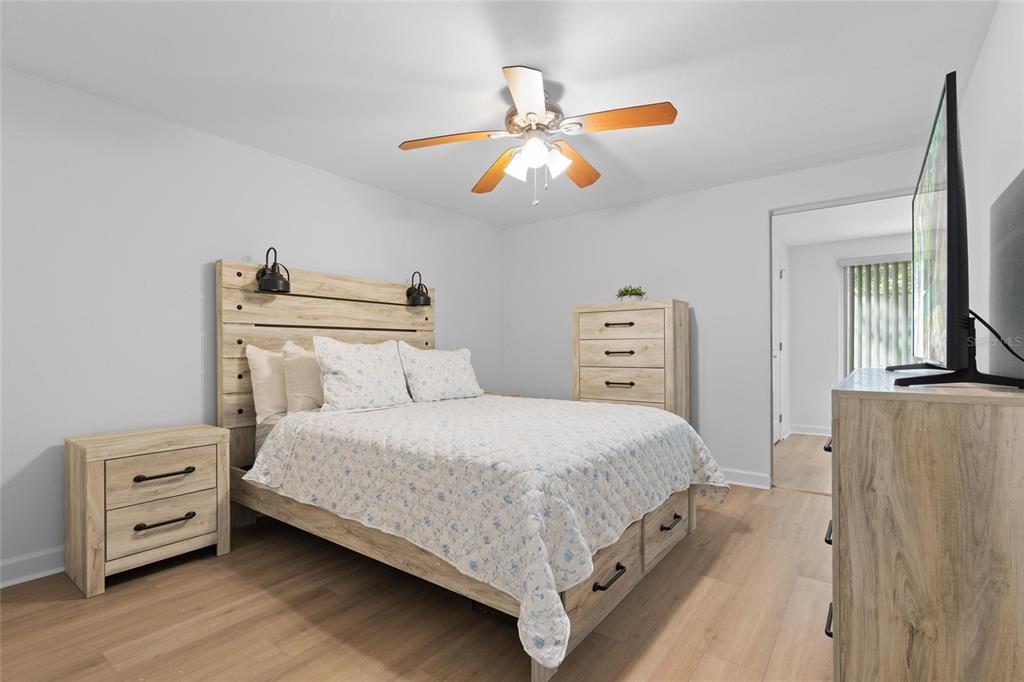 4409 Summersun Drive New Port Richey, FL 34652 - Photo 8 of 23 a bedroom with a bed and a chandelier