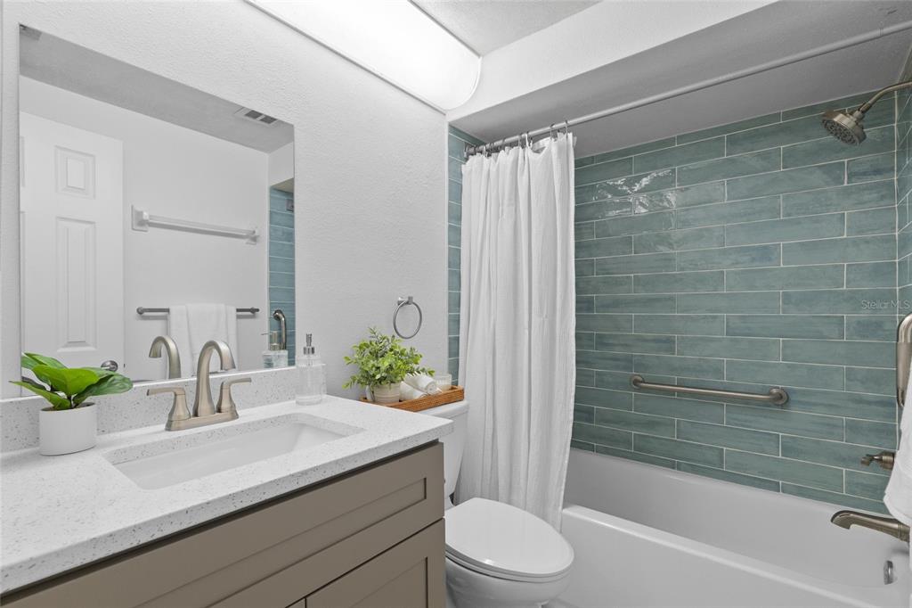 4409 Summersun Drive New Port Richey, FL 34652 - Photo 10 of 23 a bathroom with a sink a toilet a mirror and shower