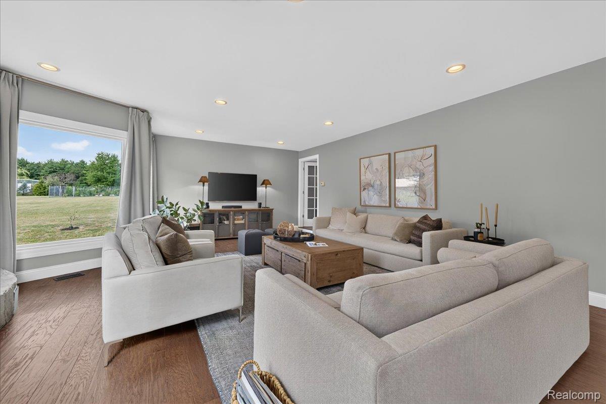7330 West Gates Street Romeo, MI 48065 - Photo 13 of 73 Spacious living area featuring wood-finish flooring, recessed lighting, expansive windows, and a neutral color palette