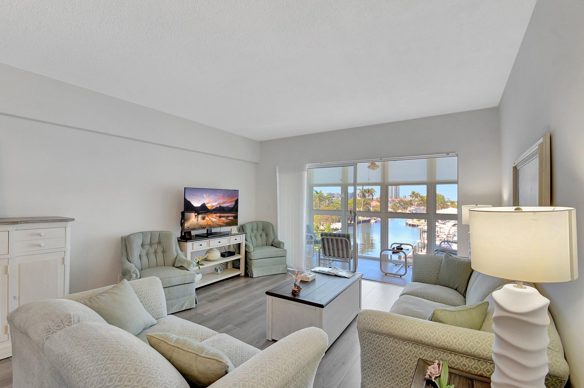 1481 South Ocean Boulevard, Unit 413A Lauderdale-by-the-Sea, FL 33062 - Photo 12 of 48 a living room with furniture and a flat screen tv