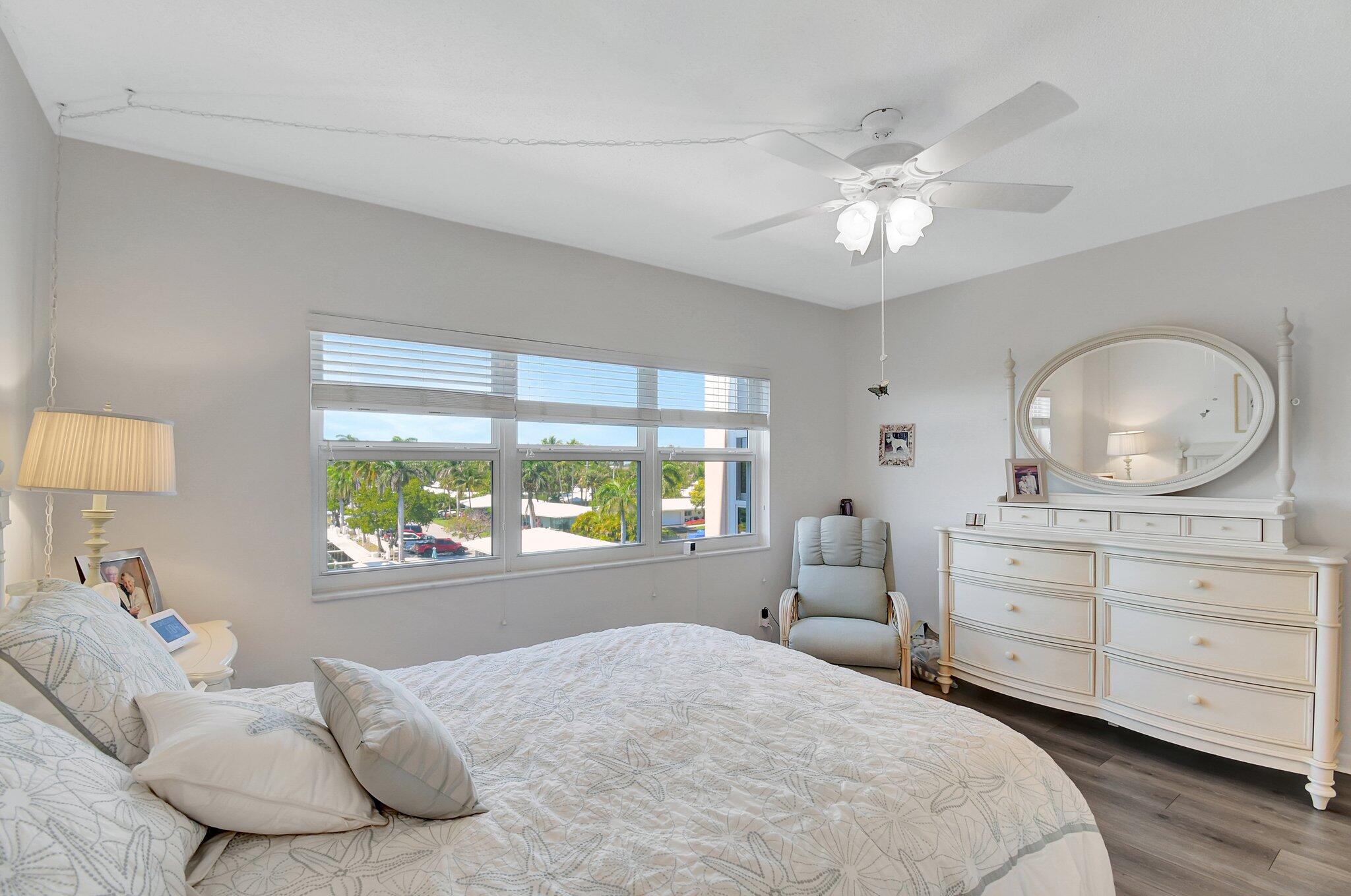 1481 South Ocean Boulevard, Unit 413A Lauderdale-by-the-Sea, FL 33062 - Photo 18 of 48 a bedroom with a large bed and a large window
