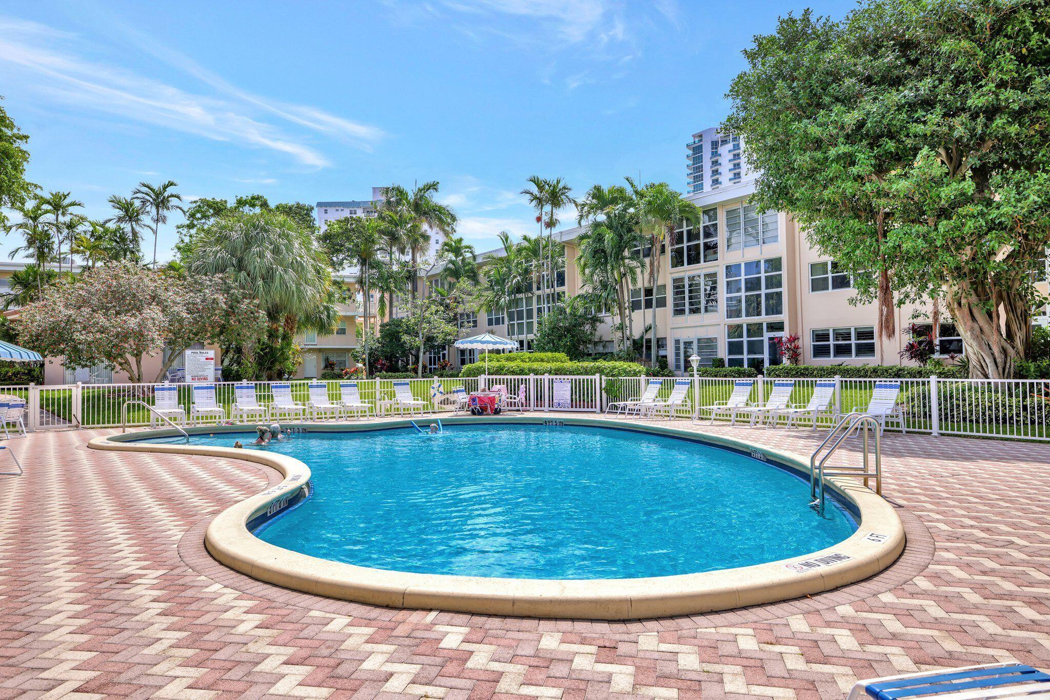 1481 South Ocean Boulevard, Unit 413A Lauderdale-by-the-Sea, FL 33062 - Photo 35 of 48 a view of a swimming pool in a backyard