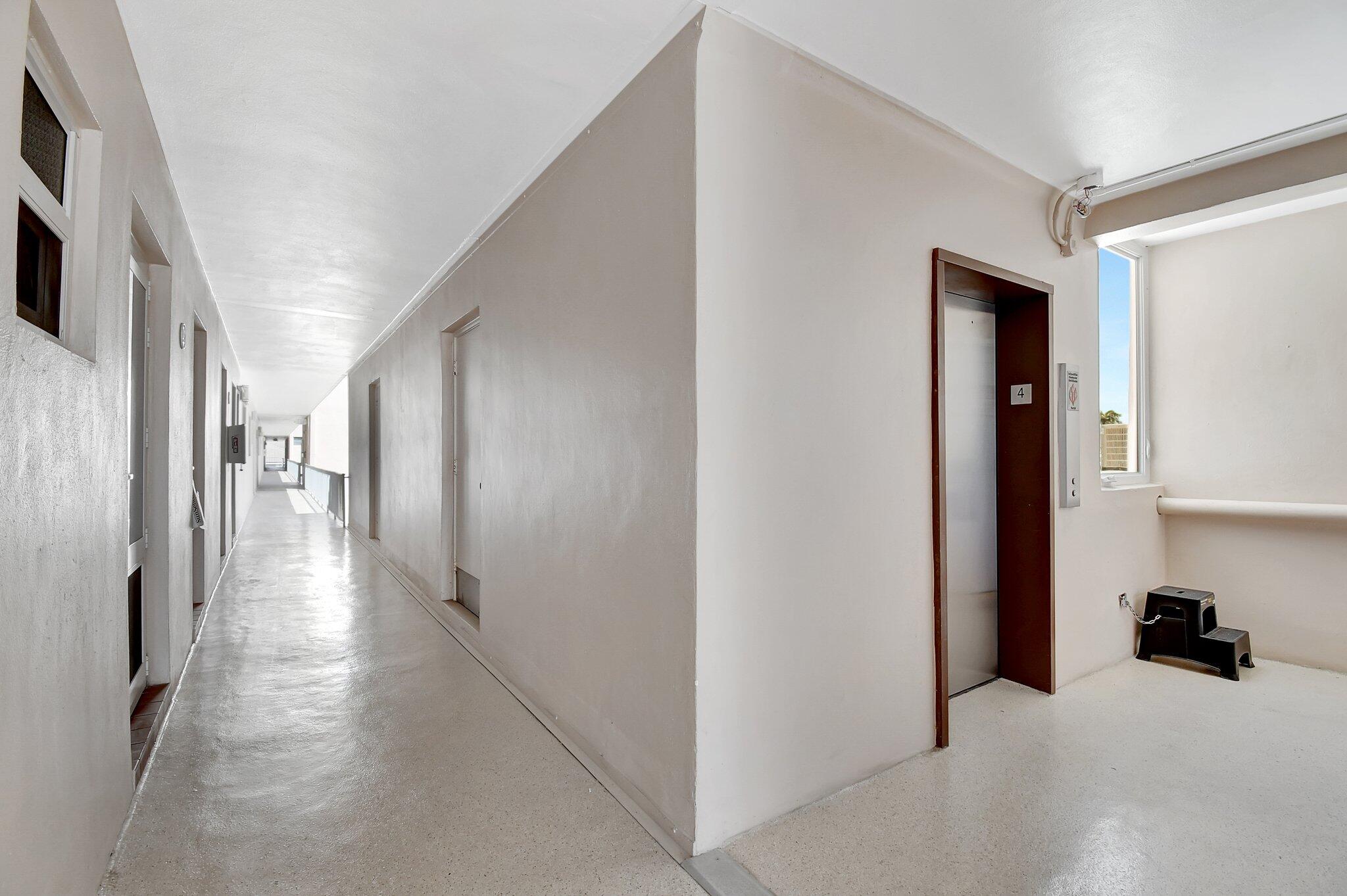 1481 South Ocean Boulevard, Unit 413A Lauderdale-by-the-Sea, FL 33062 - Photo 39 of 48 a view of hallway with furniture and a refrigerator